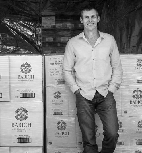 David Babich standing with crates of Babich wine