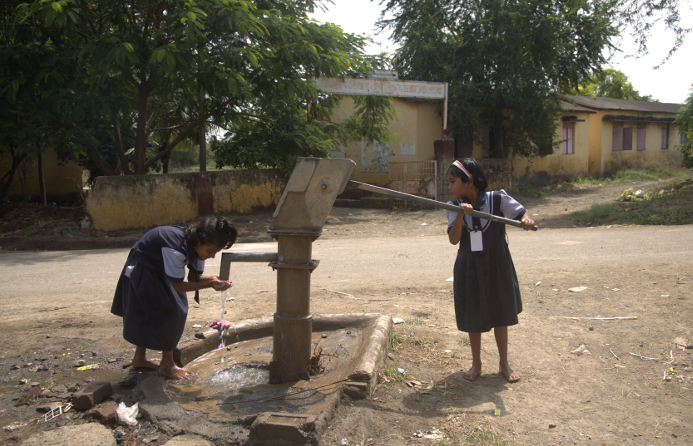 Sirsao school children pumping water when the supply pipes stop working